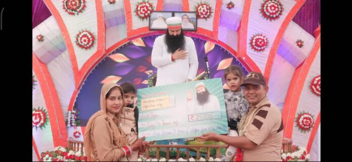 Dera chief Gurmeet Ram Rahim giving the check